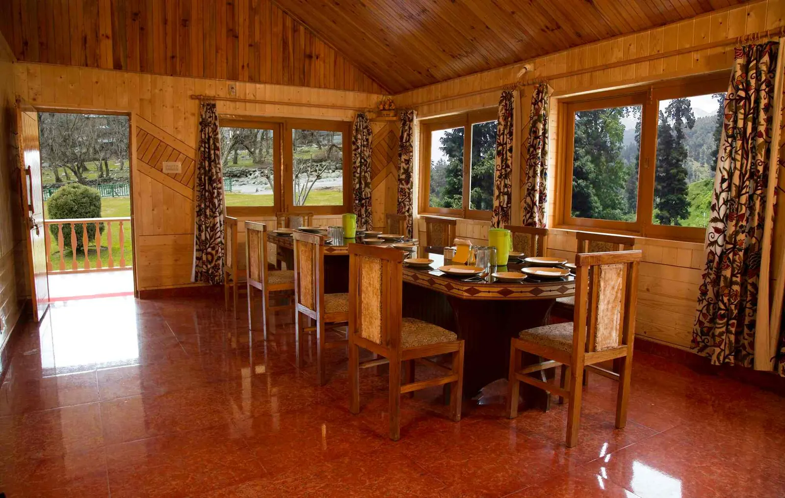 Wood-panelled dining hall with valley views at Tulip Cottage