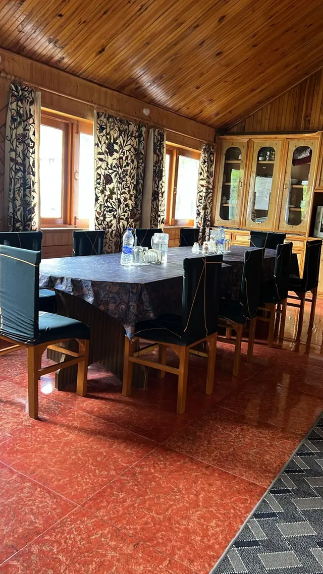 Dining space with crewel-embroidered Kashmiri curtains