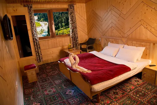 Premium double room with pine panelling and Kashmiri carpet at Tulip Cottage Pahalgam