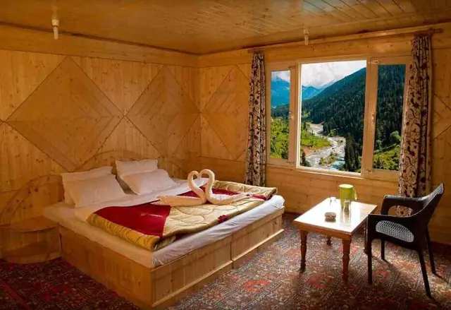Deluxe room with river and forest view from the window at Tulip Cottage Pahalgam